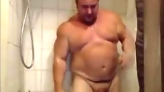 Handsome bear taking a shower.